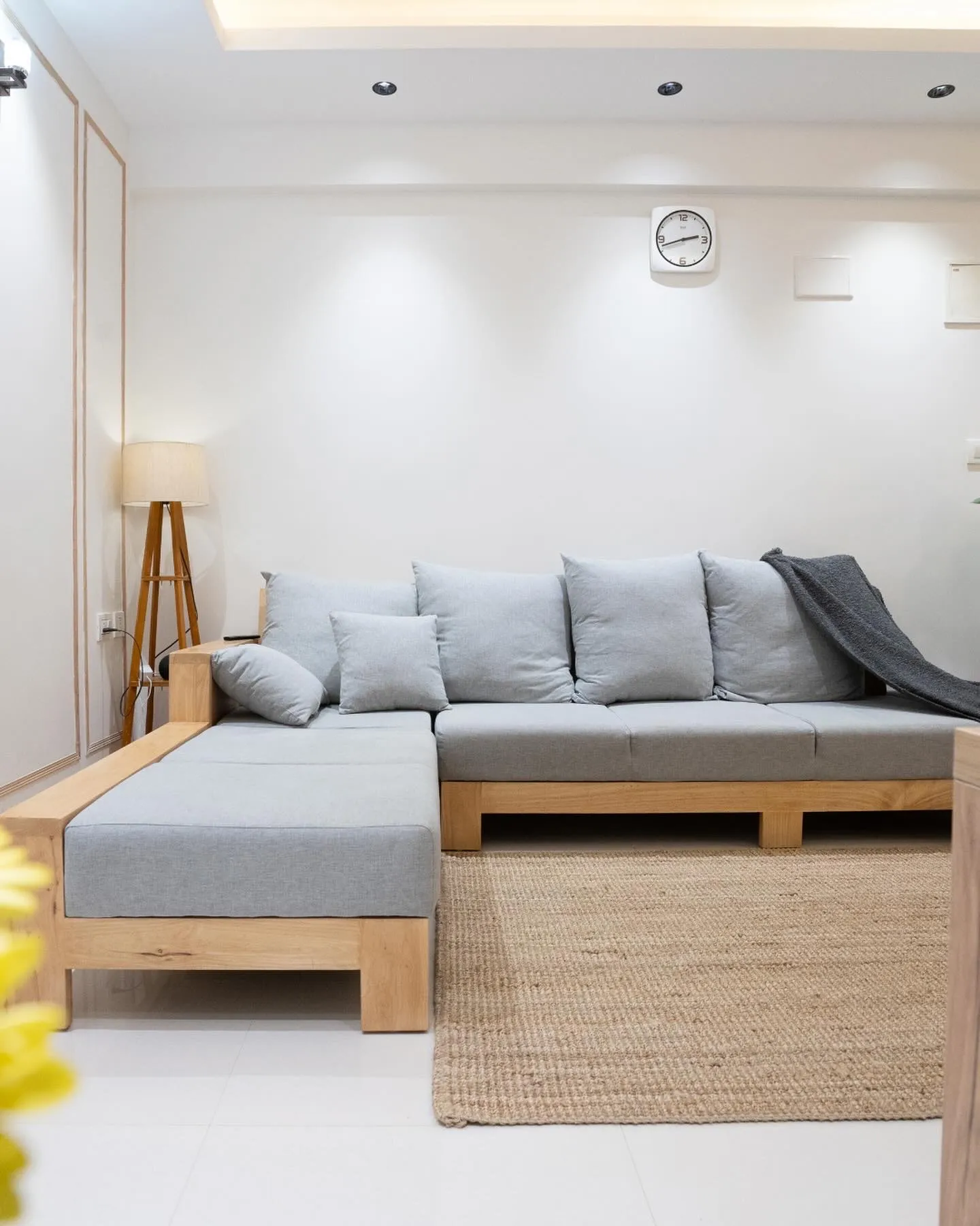 Grey L-shaped sofa on an oak base with jute rug — The Aakar
